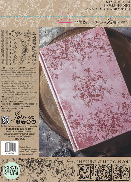 Decorative notebook with floral design, stamped from IOD's Flora and Vine stamp, on a textured background.
