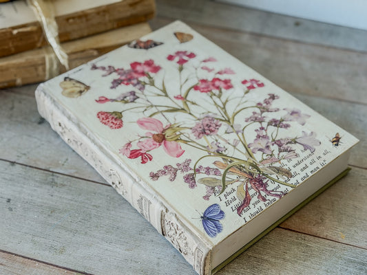 Book with floral and butterfly design from the Primrose Isle transfer on a wooden surface.