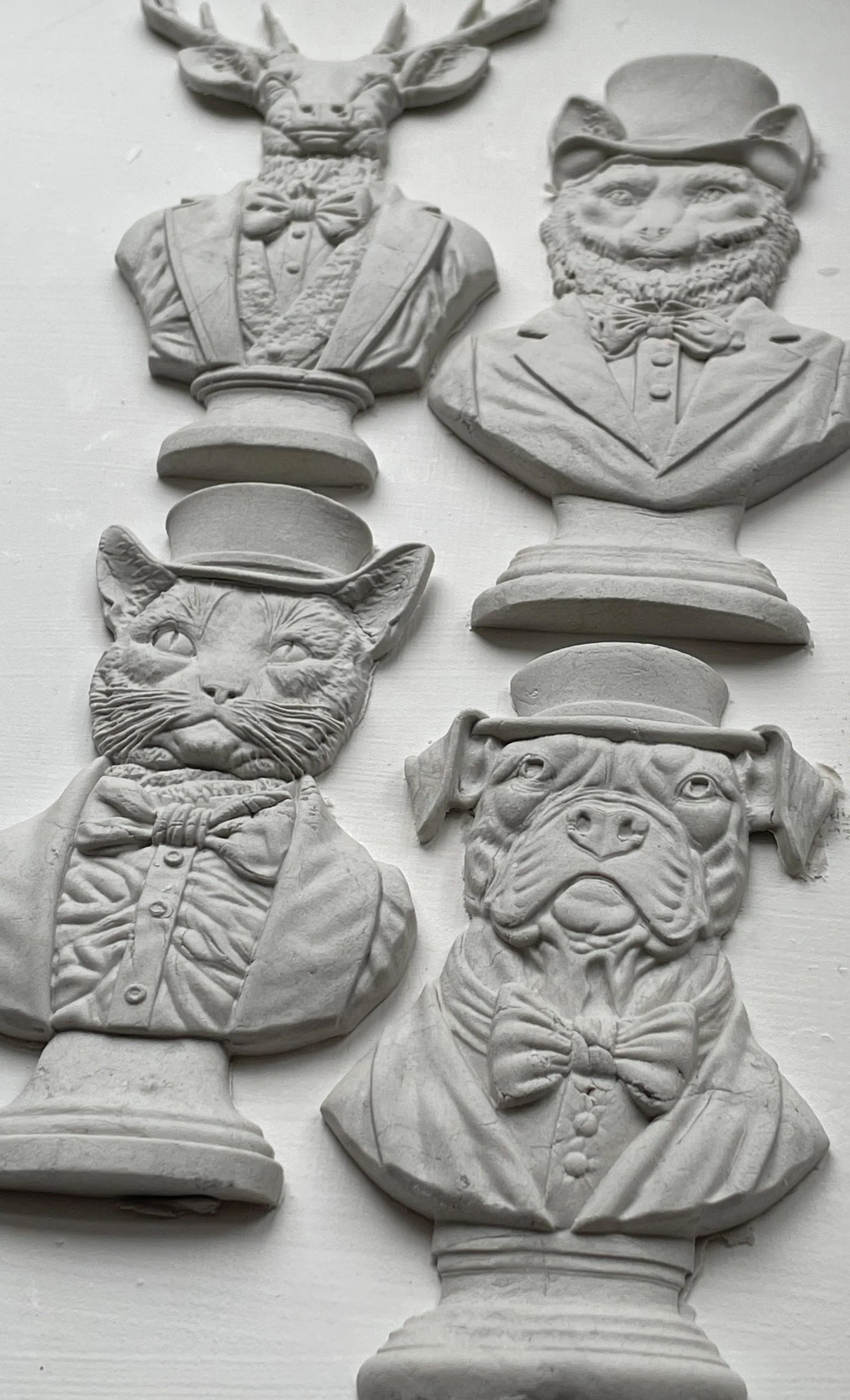 Clay castings of four different animals busts, made from the IOD mould 'Invitation Only'.