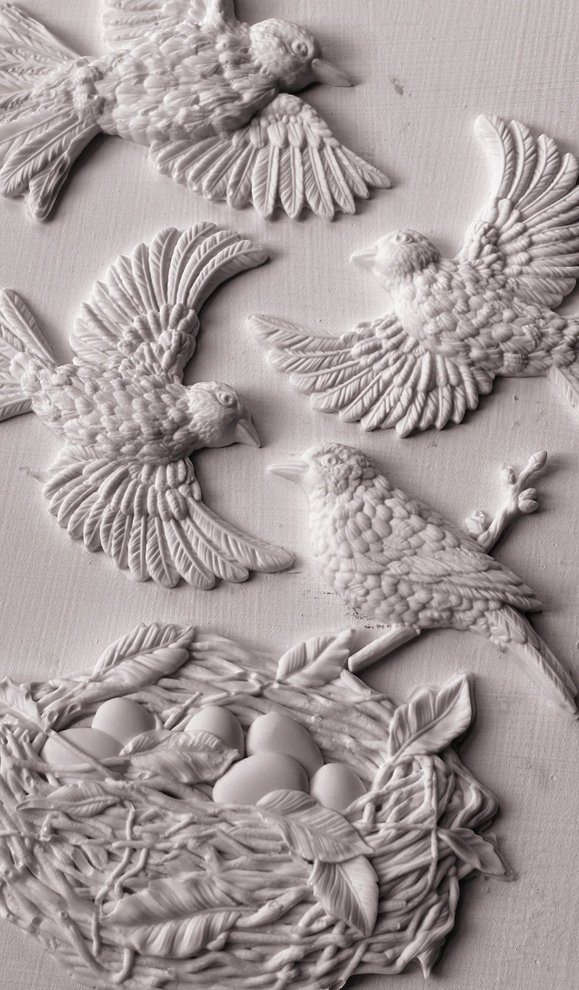Clay castings from IOD's 'Sparrow's Nest' mould with the castings of birds and a next fastened to wood.
