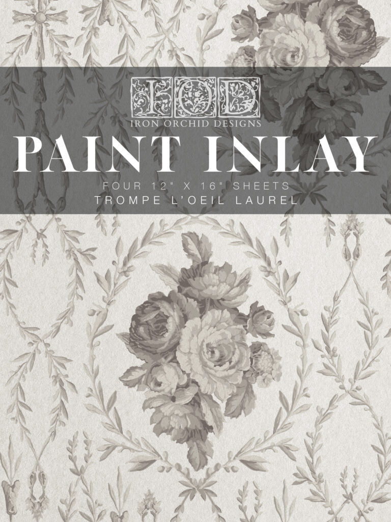 Packaging for IOD Paint Inlay 'Trompe L'oeil Laurel' with a floral laurel design.