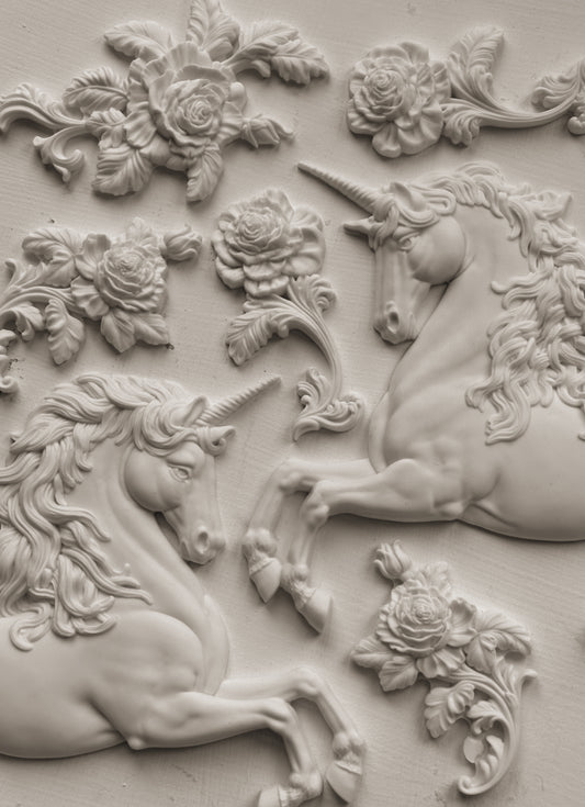 Clay castings of unicorns and flowers attached to the wall, created using the IOD 'Unicorn' Mould.