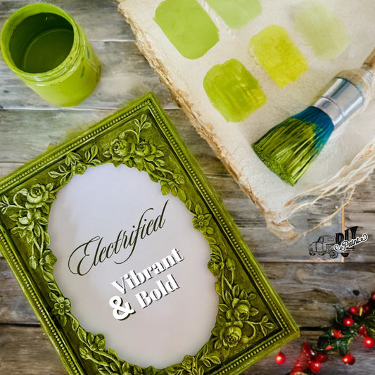 A frame painted in the green color "Electrified" with an open jar, used brush, and green swatches alongside it.