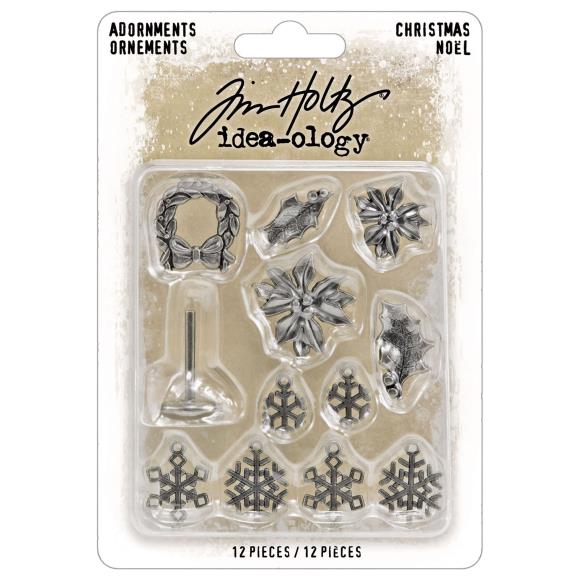 Packaged set of Christmas-themed metal embellishments with Tim Holtz branding on a beige background.
