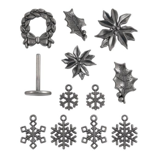 Collection of Tim Holtz's silver Christmas-themed jewelry charms & embellishments on a white background