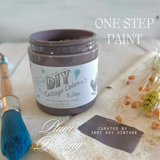 An open 8 oz. jar of purple chalk paint in the shade "Plum Pudding" from DIY Paint Co.