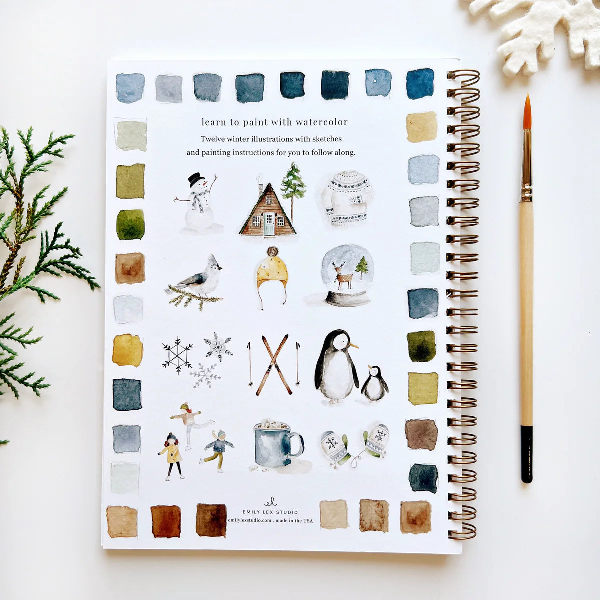 The back cover of the Winter Watercolor Workbook from Emily Lex Studio. It shows 12 different winter themed watercolor illustrations.