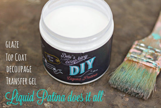 A container of Clear Liquid Patina with a brush next to it, indicating a do-it-yourself paint product.