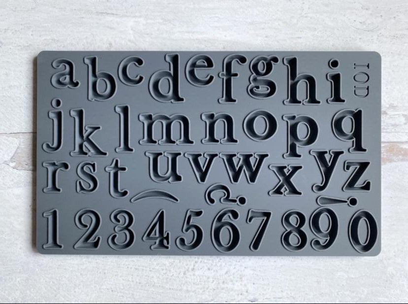 The mould "Harper" from IOD, showing the whole alphabet and 10 numbers. The mould is sitting on a white table.
