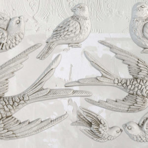 Clay castings from an IOD decorative mould called "Birdsong", featuring a pattern of birds in flight, primarily in a grey color.
