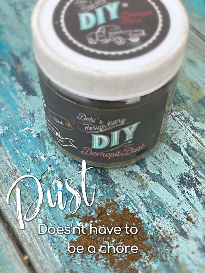 A container labeled 'DIY Decrepid Dust' on a wooden surface with some dust spilled in front.
