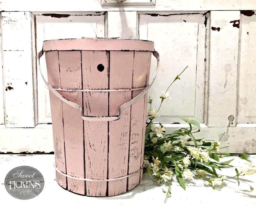 A wooden bucket painted pink in the shade "First Crush".