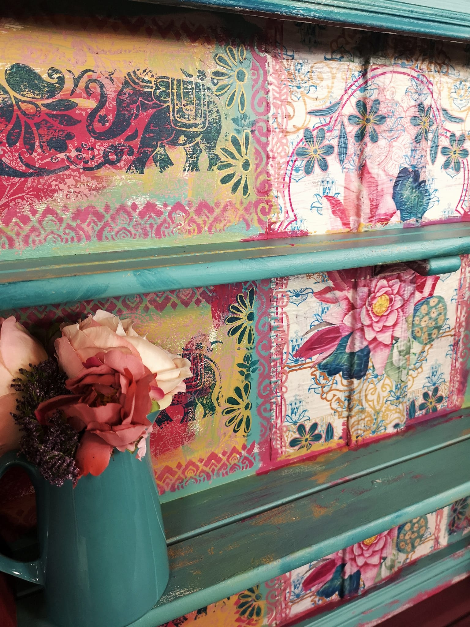 A green shelf with the Lotus Love decoupage paper decoupaged to the backing.