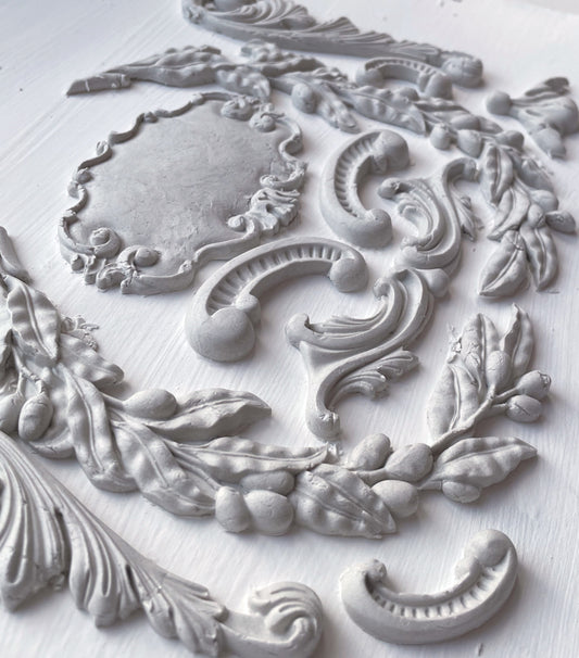 A casting from the Olive Crest mould, with dried clay castings of olive branches and classical flourishes.