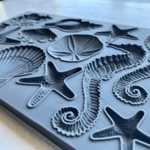 An IOD decor mould with sea shell designs, including starfish and various shell shapes.
