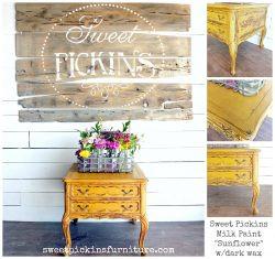 A nightstand painted in "Sunflower" milk paint with a "Sweet Pickins" sign hanging above it.