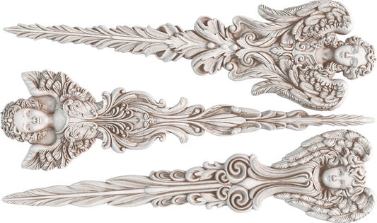 A set of white Angelic Tapers clay castings with ornate designs and angel motifs.