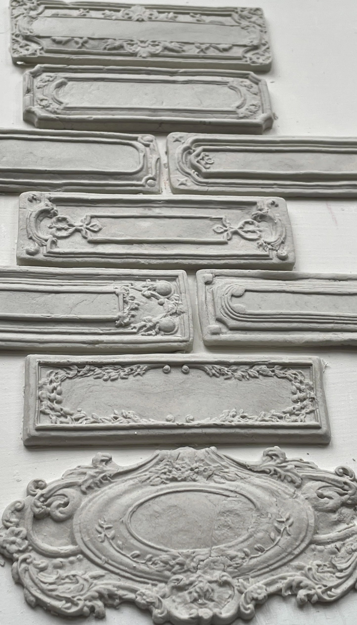 Clay castings of vintage labels and frames created with the 'Conservatory Labels" mould.