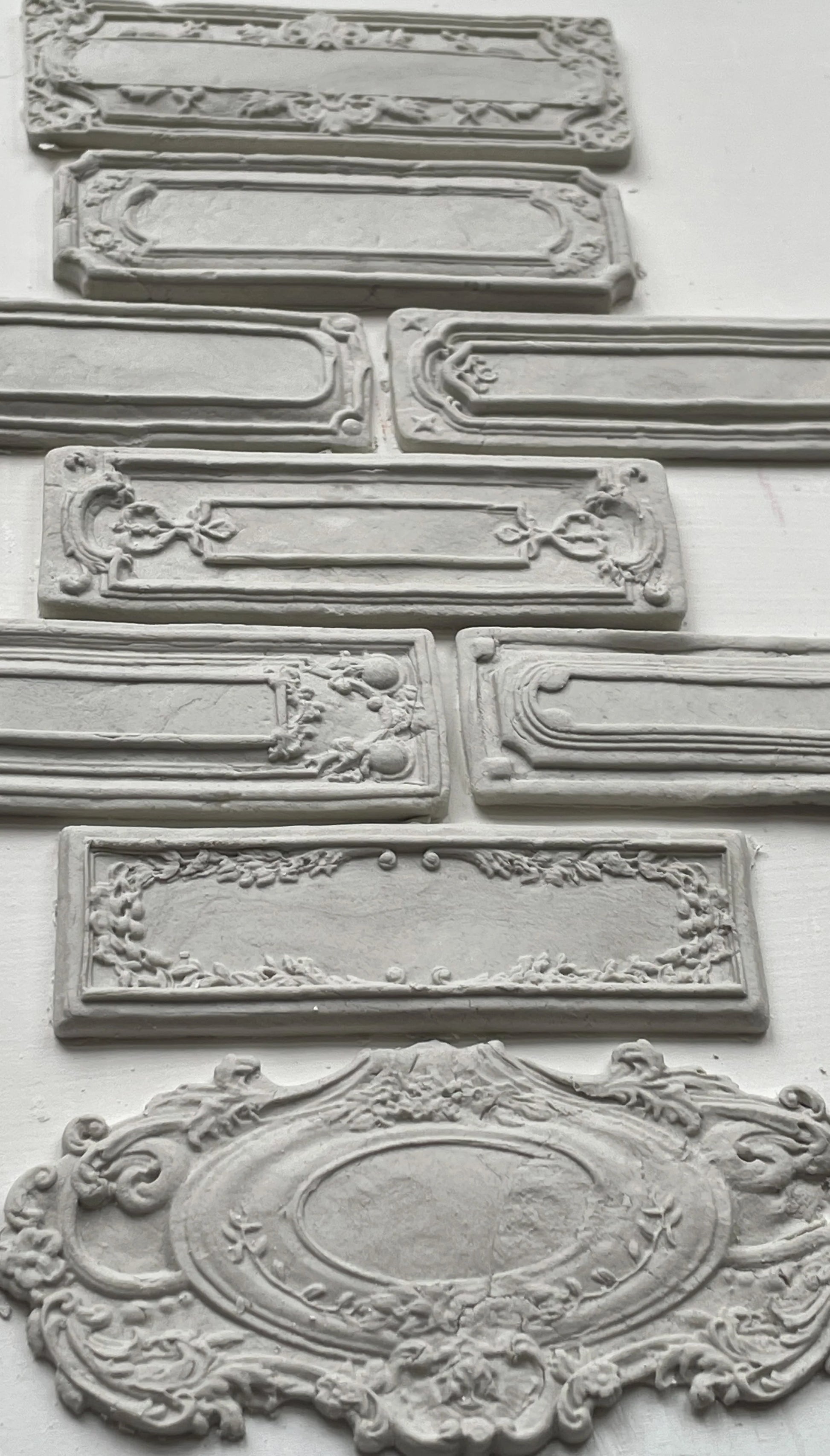 Clay castings of vintage labels and frames created with the 'Conservatory Labels" mould.