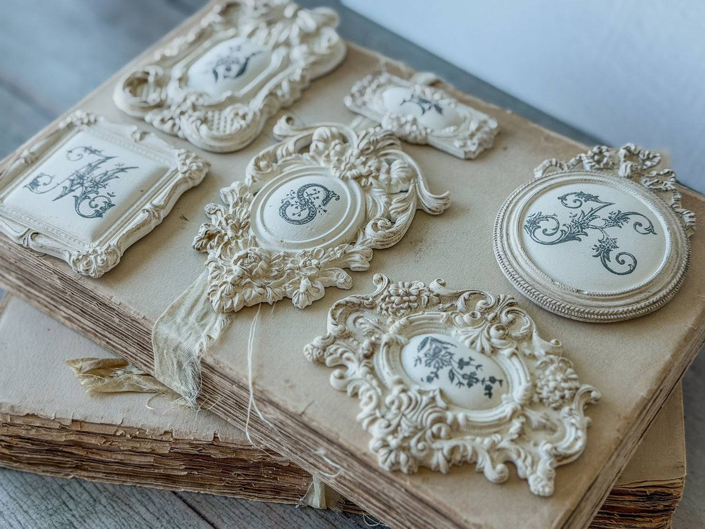 Ornate stamped miniature stamps on a wooden surface.