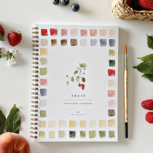 Front Cover of an Emily Lex watercolor workbook titled 'Fruit' with a brush and fruits on a white surface