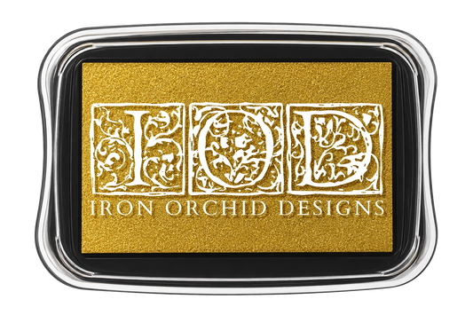 Iron Orchid Designs ink pad in a rectangular case with a gold ink bed and white ornate lettering that reads 'IOD' and 'IRON ORCHID DESIGNS'.