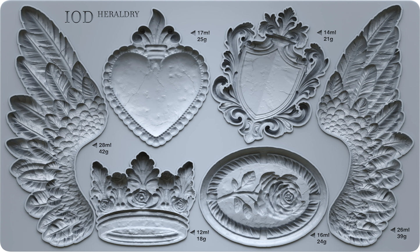 An IOD mould featuring shapes of crests, wings, and decorative elements, with measurement markings on the sides.