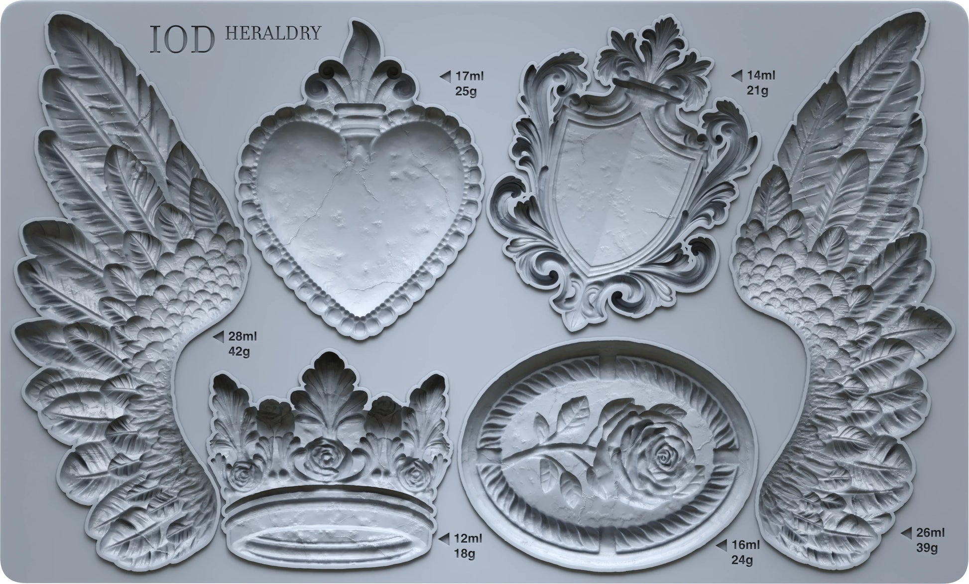An IOD mould featuring shapes of crests, wings, and decorative elements, with measurement markings on the sides.