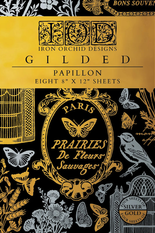 Gilded Papillon transfer pad with floral and butterfly patterns on a black background