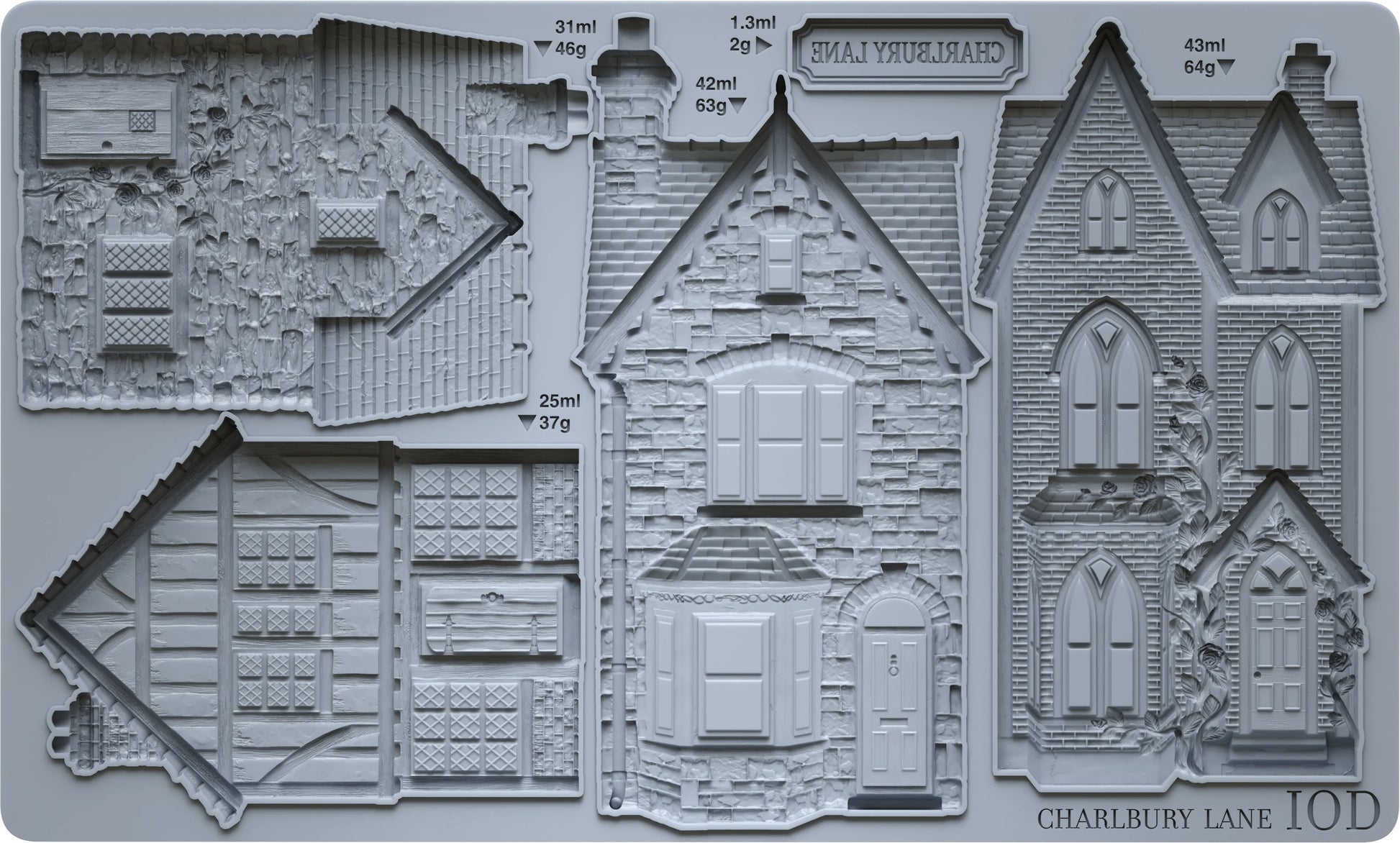 A gray silicone mould featuring detailed embossed house designs and architectural sections, with a printed label including 'CHARLBURY LANE'.