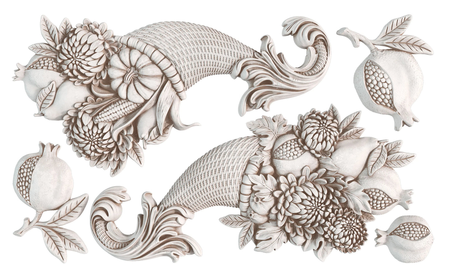 A set of decorative air dry clay castings of classical cornucopiaes filled with floral arrangements and pomegranates, shown on a plain white background.