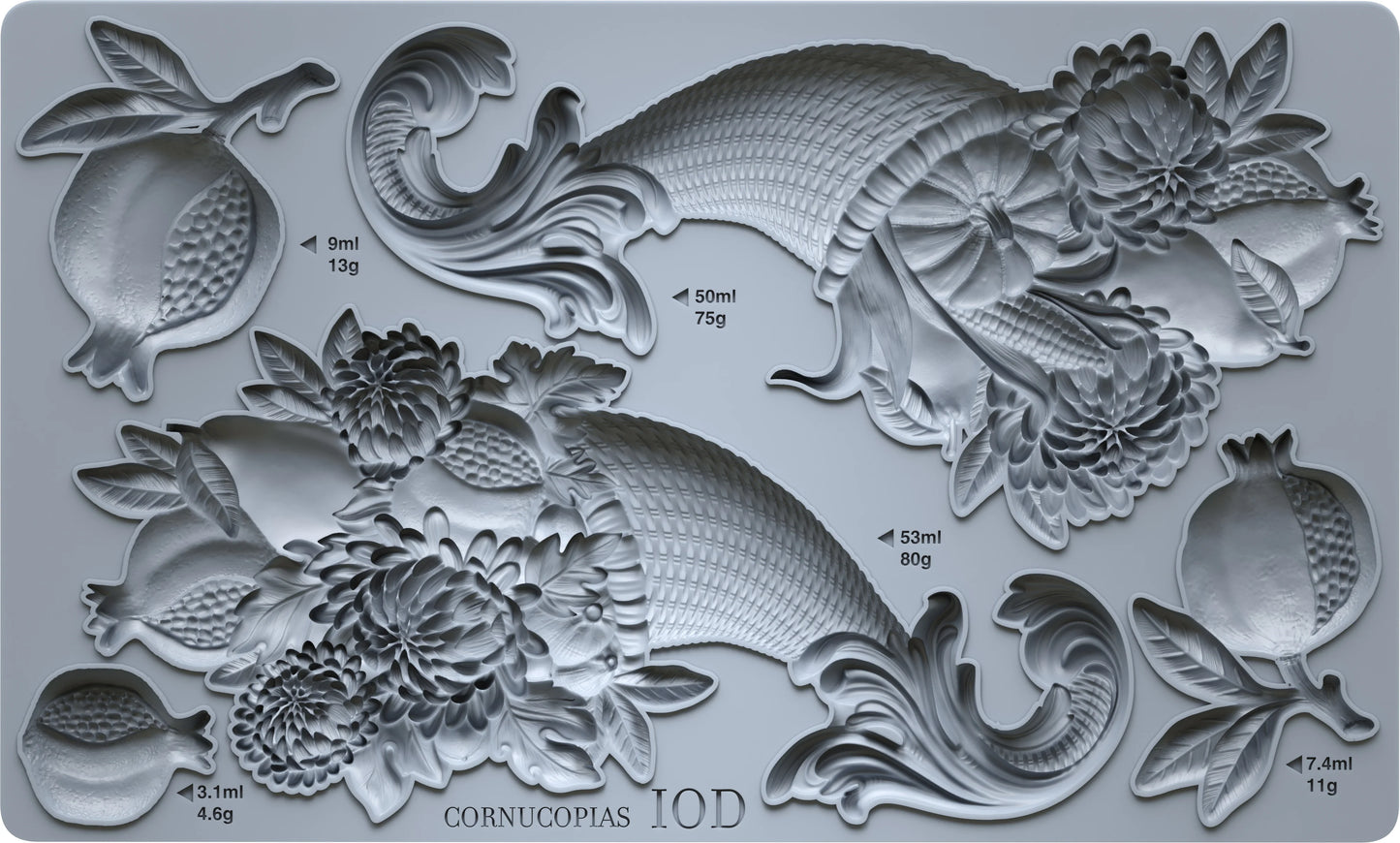 A gray silicone mold tray featuring embossed relief designs of fish, pomegranates, and floral motifs, with printed volume and weight labels in milliliters and grams. The text 'CORNUCOPIAS IOD' is printed at the bottom.