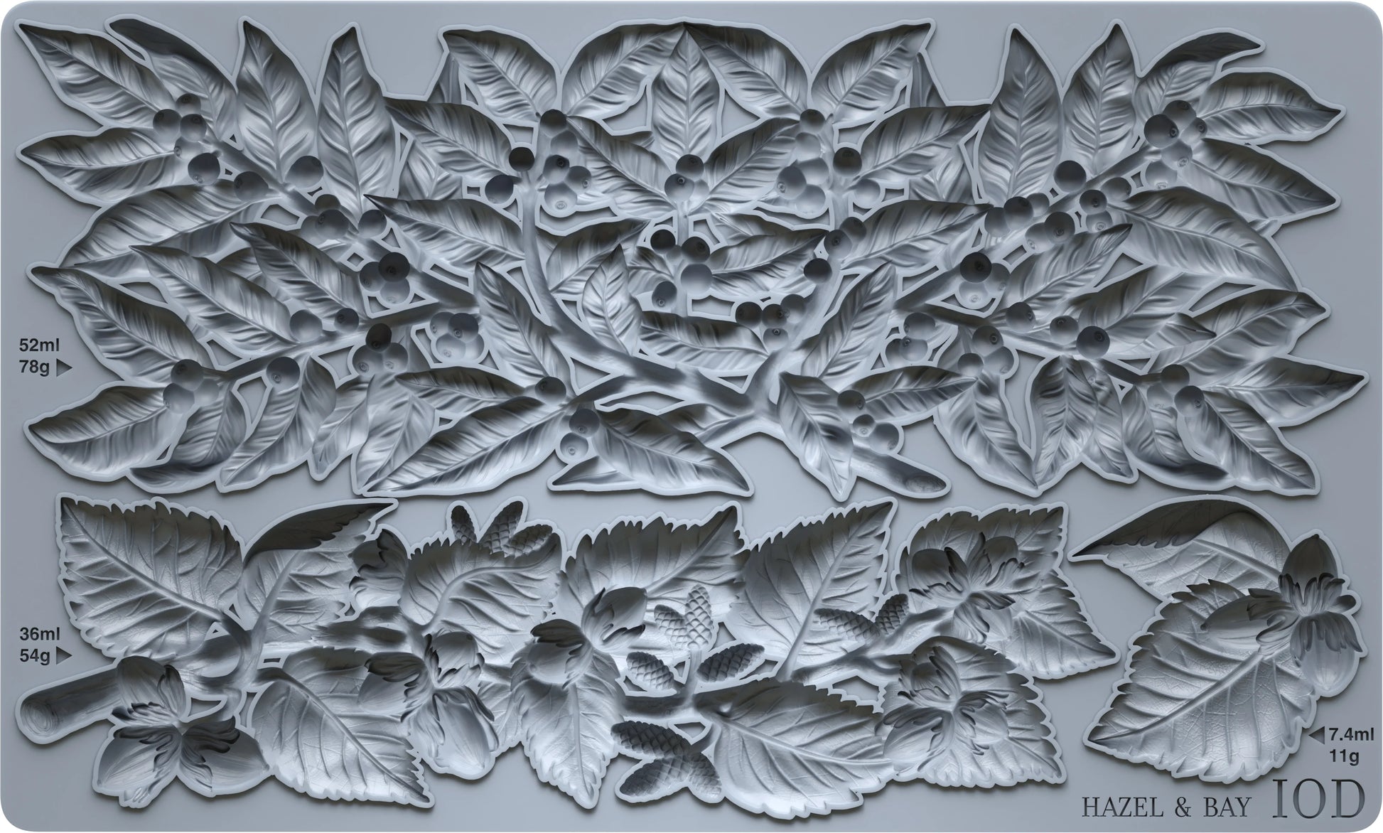 A gray silicone mould featuring a detailed relief pattern of hazelnuts, leaves, and berries, with printed dimensions and the brand name 'HAZEL & BAY' visible in the bottom right corner.