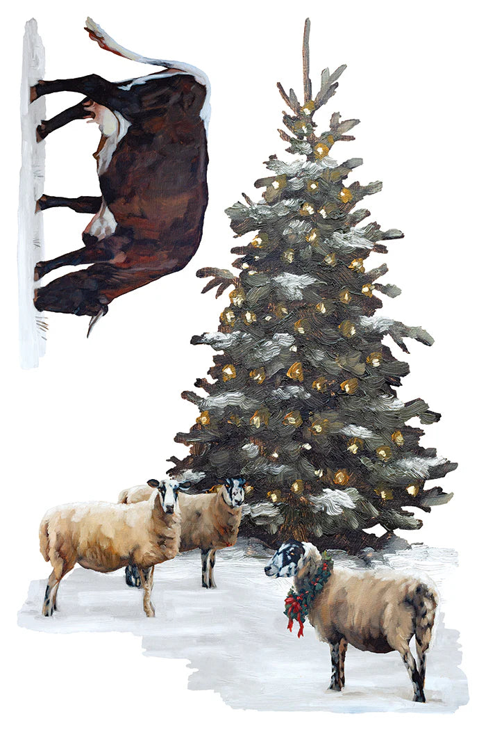 A transfer paper with a winter illustration featuring a snow-covered evergreen tree with warm lights, several sheep in the snow, and a dark horse hanging from a snowy wall on the left, all on a white background.