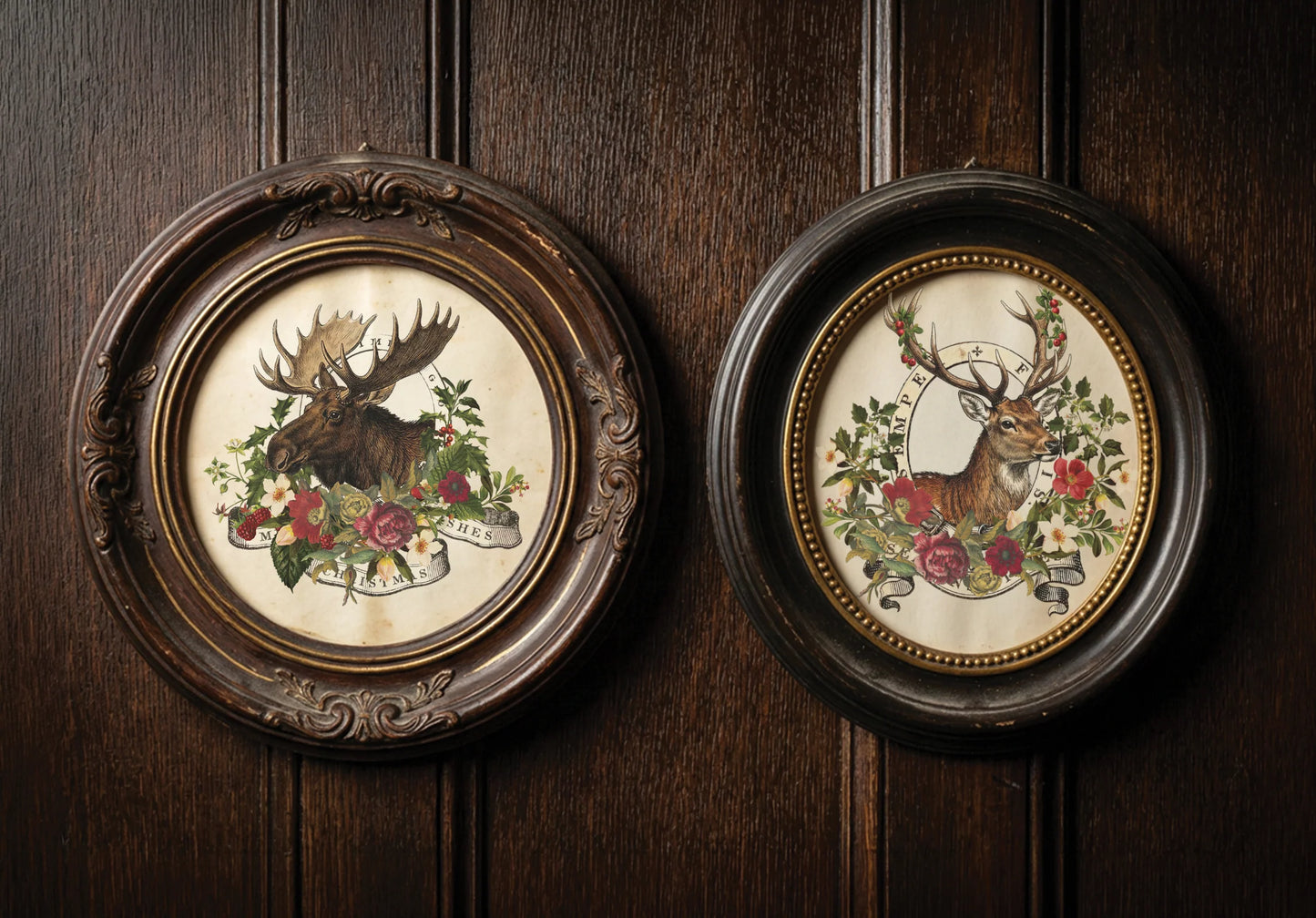 Two round framed wall art pieces hanging on a dark wood paneled wall. The left frame shows a moose surrounded by flowers, and the right frame shows a deer surrounded by flowers, both in ornate dark wood frames.