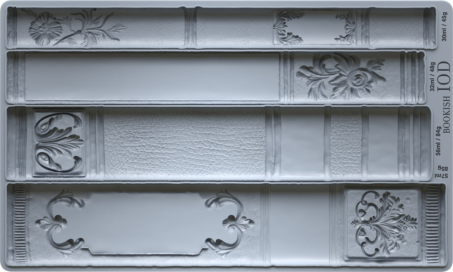Decorative book mold with intricate designs on a gray background