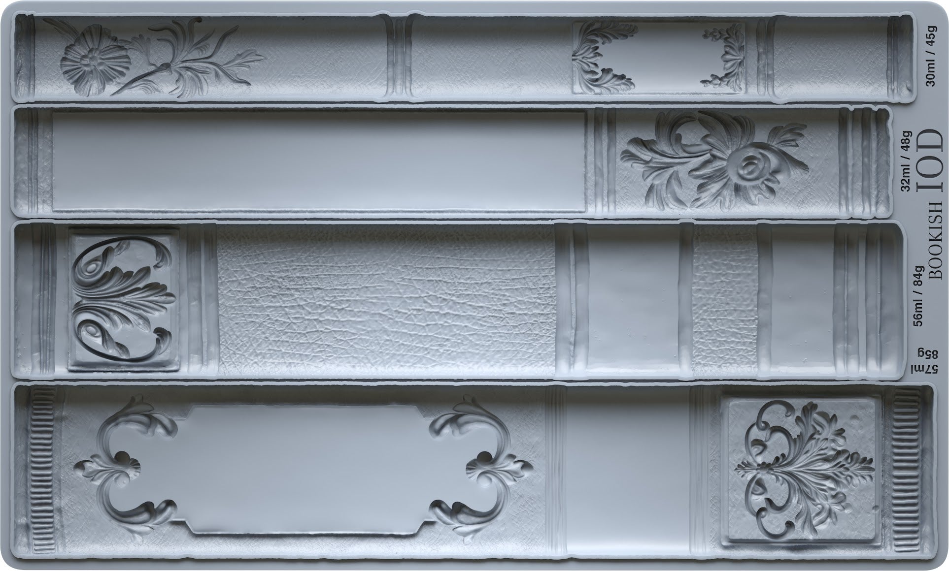 Decorative book mold with intricate designs on a gray background