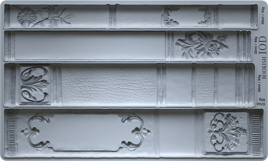 Decorative book mold with intricate designs on a gray background