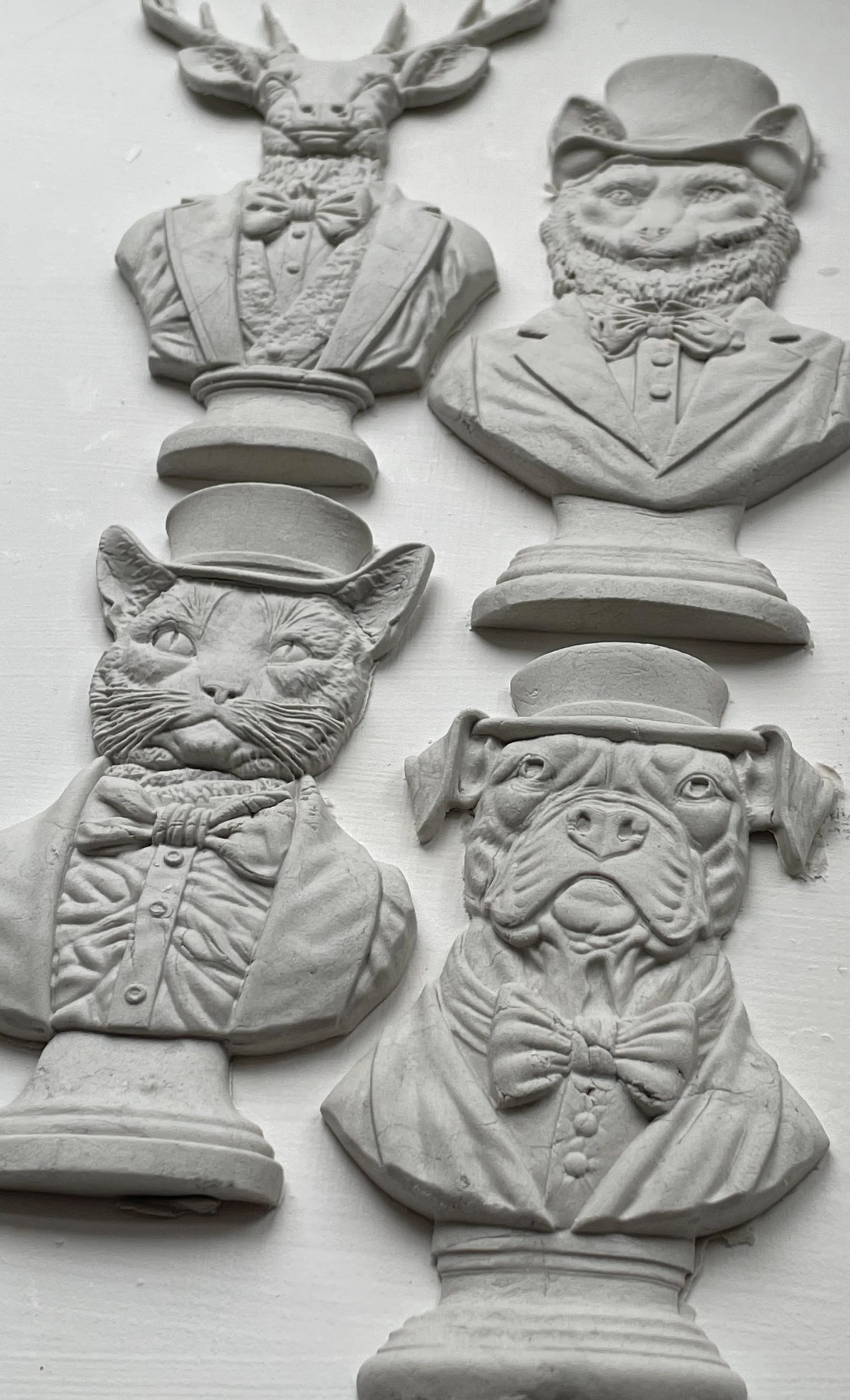 Clay castings of four different animals busts, made from the IOD mould 'Invitation Only'.