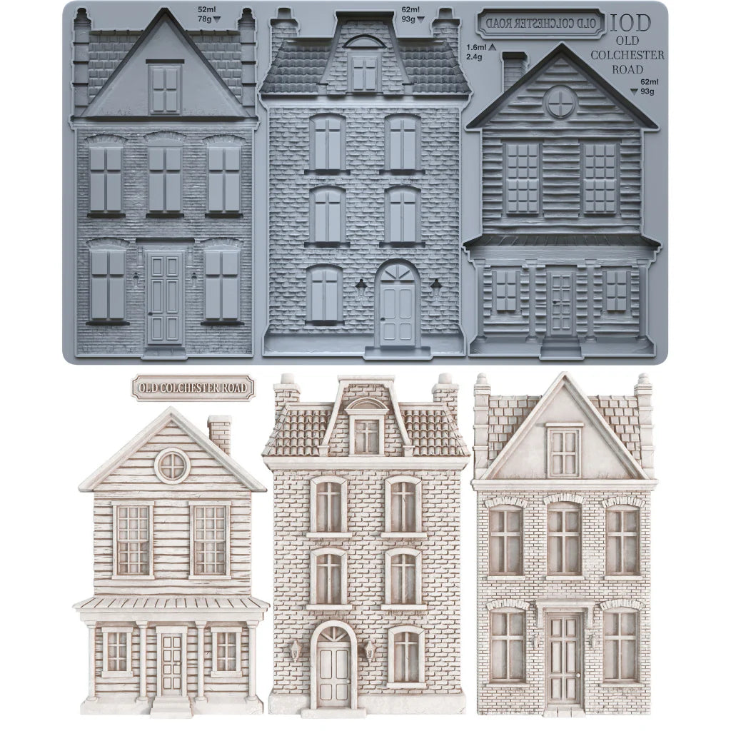 A set of miniature Victorian-style house molds and clay castings, including a gray silicone mould tray at the top and three finished light beige house cutouts below on a white background.