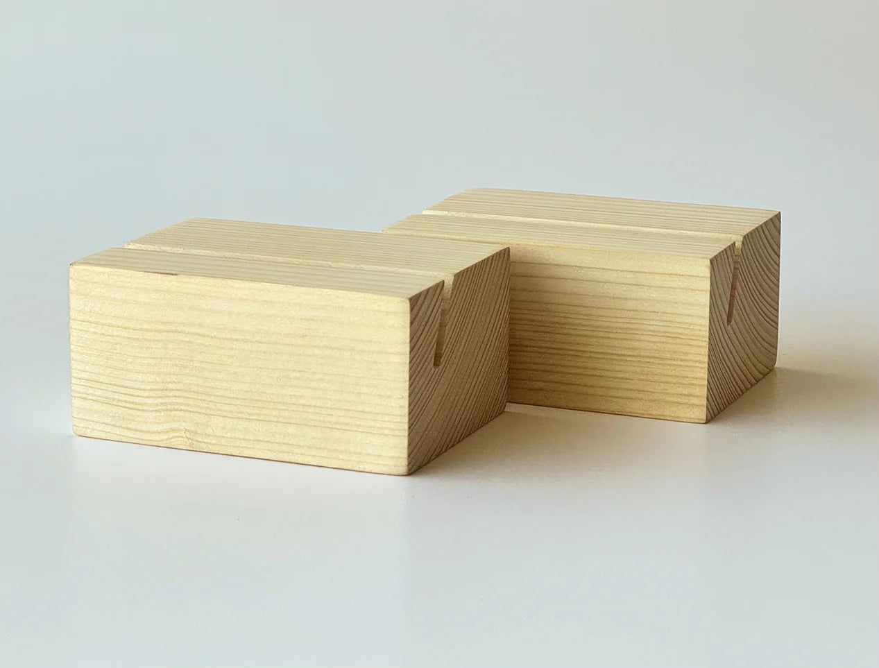 Two rectangular light wood blocks with visible grain and small notches on the sides, photographed on a clean white studio background.
