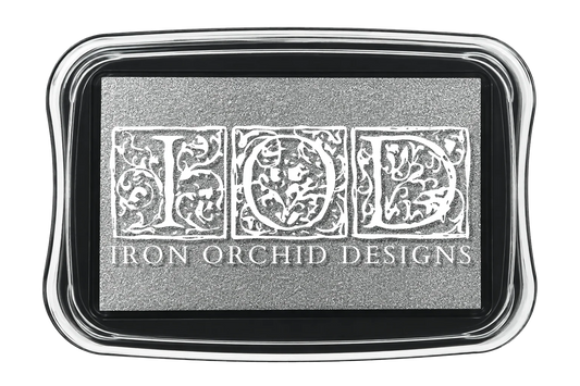 A rectangular ink pads in silver pigment with the words "Iron Orchid Designs" on the lid