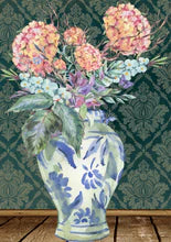 A decoupage paper featuring a blue and white vase with pink flowers up against a green wall.