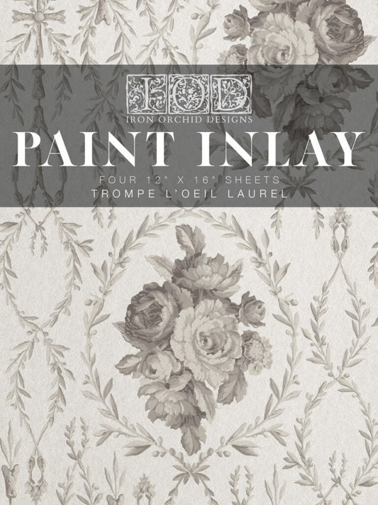Packaging for IOD Paint Inlay 'Trompe L'oeil Laurel' with a floral laurel design.