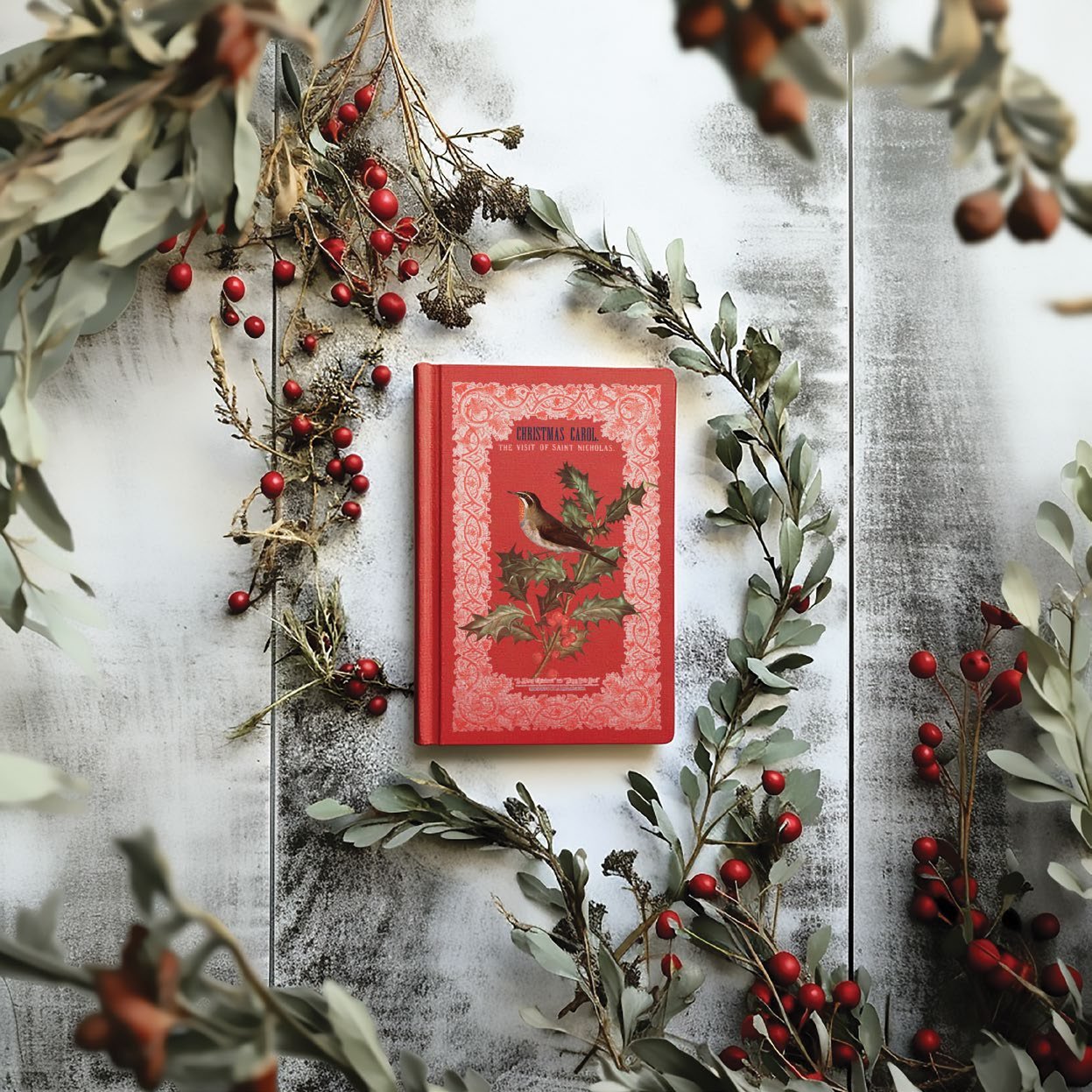 Red book with bird and holly design from the "Winter Botanist" transfer by IOD.