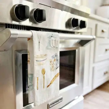 Stainless steel oven with a decorative kitchen towel hanging on the handle