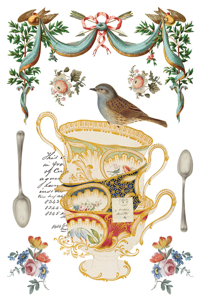 Transfer sheet with decorative illustration of a teacup, spoons, and floral elements with a bird.