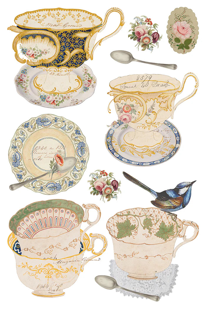 Transfer sheet with a collection of decorative teacups, saucers, and spoons with floral and intricate designs on a white background.