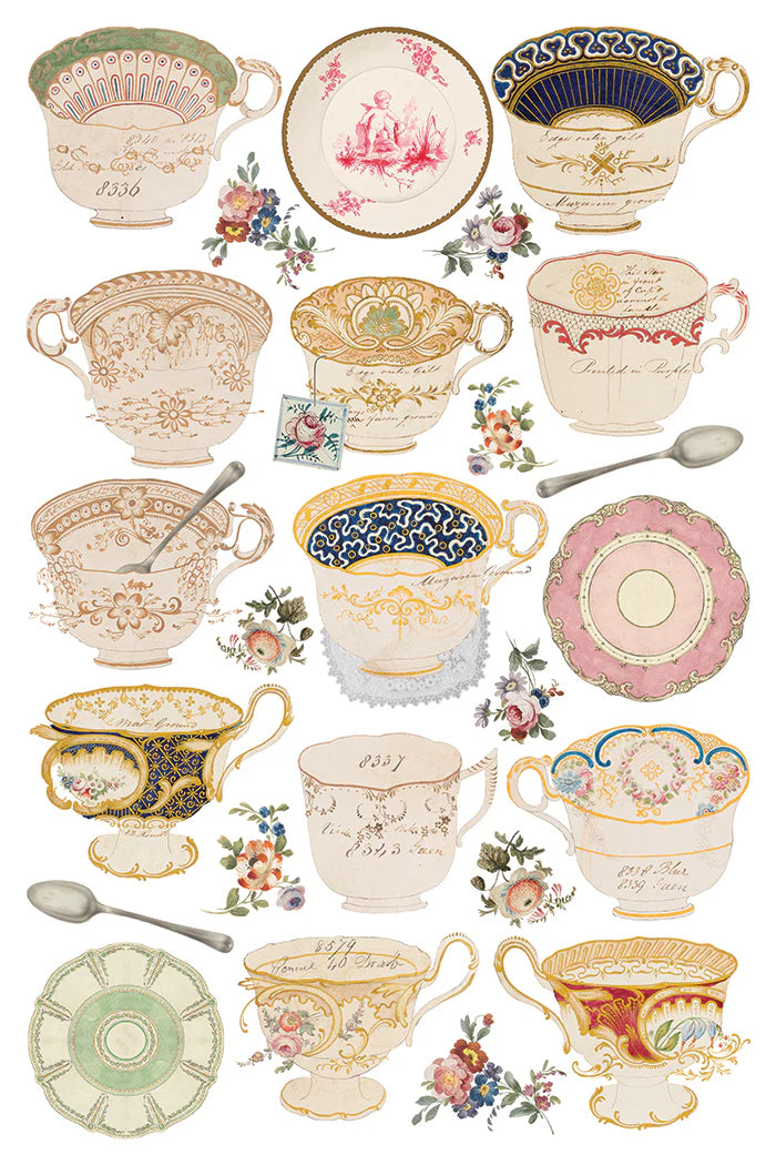 Transfer sheet showing a collection of decorative teacups and saucers with floral patterns and spoons on a white background.
