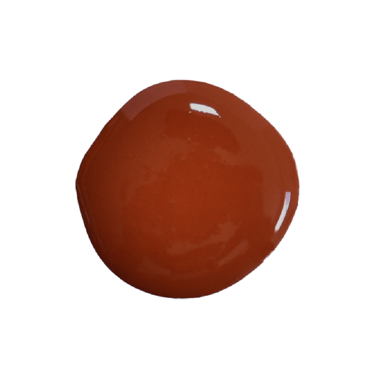 A dollop of red milk paint in the color "Cherry Pie", on top of a white surface.